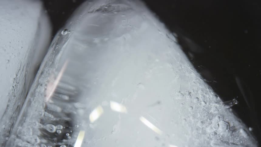 Bubbles rise to the surface of frozen water as it melts