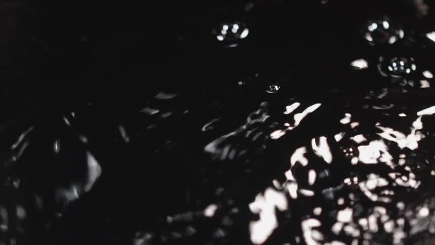 The surface of water rippling and bubbling