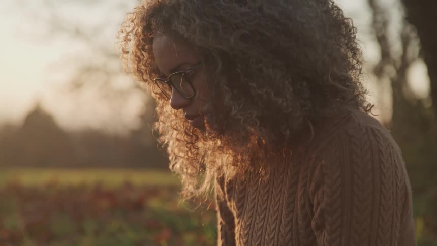 A woman is wearing glasses outside