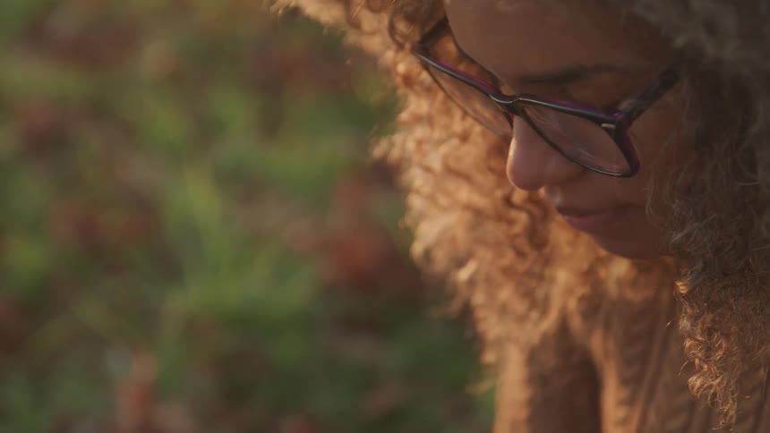 A woman is looking down outside