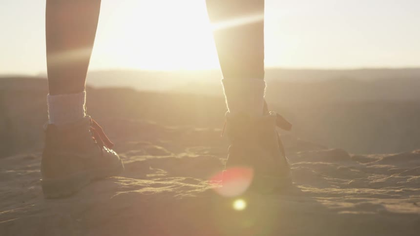 A person standing outside looks out at the landscape