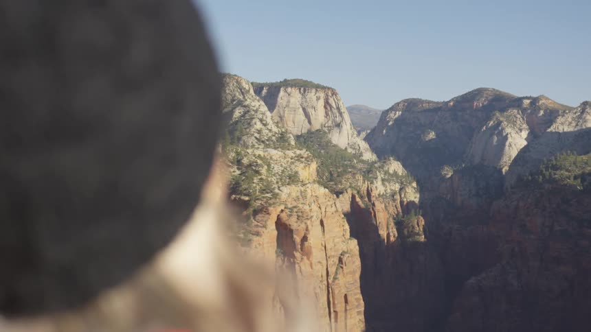 A female standing outside around mountains