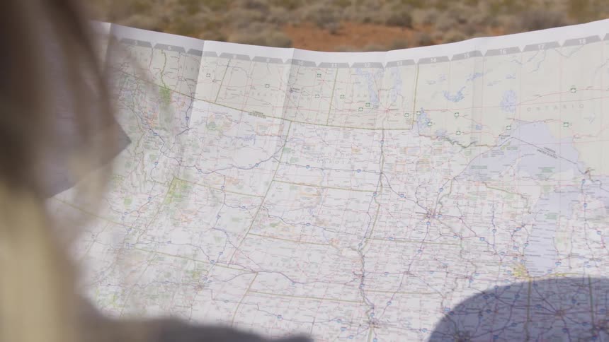 Woman with brown hair looks at map