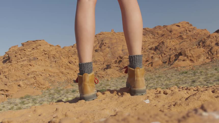 A woman is hiking outdoors in the daytime
