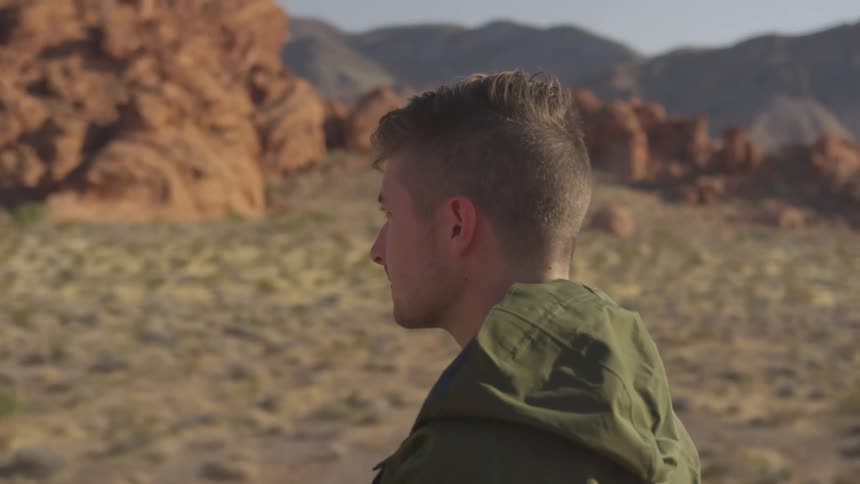 A man is hiking outdoors while wearing a jacket