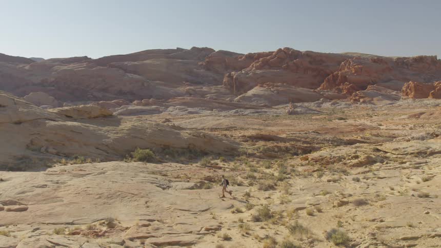 A person hiking across a desert area