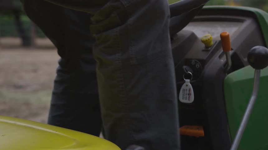 A man gets on a tractor