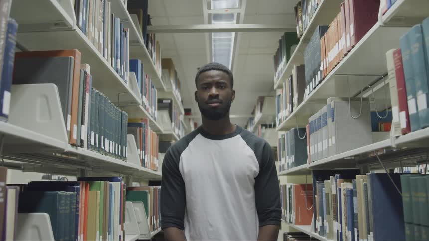 A man standing in a school library