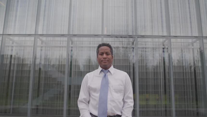 A man standing outside an office building