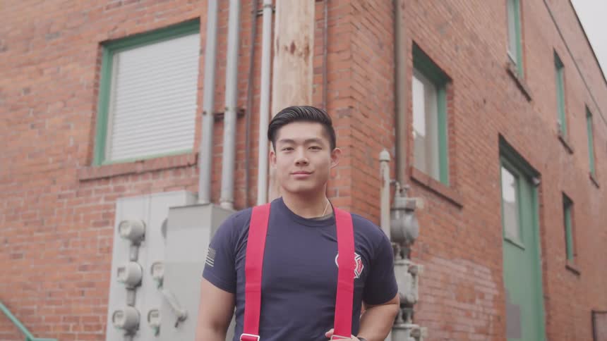 Firefighter stands outside building