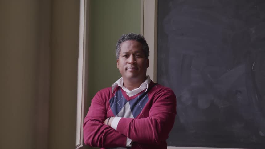 A teacher in front of a black board