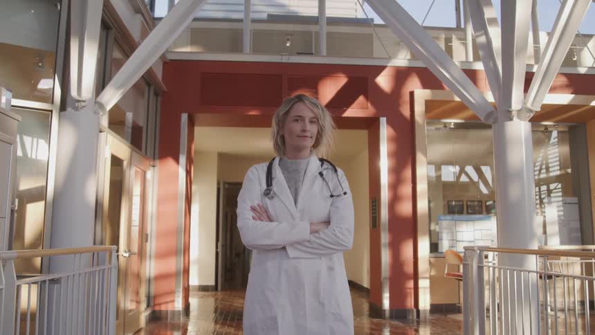 Female doctors stand between rails in building