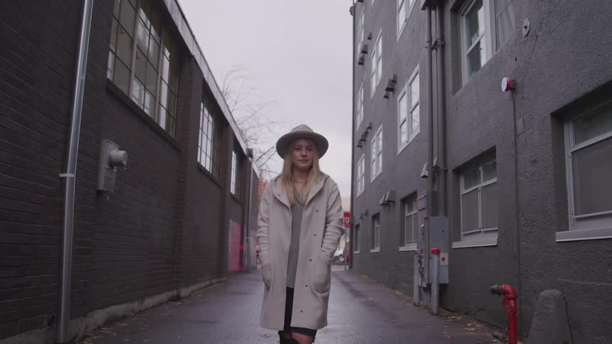 A woman is standing in a downtown city