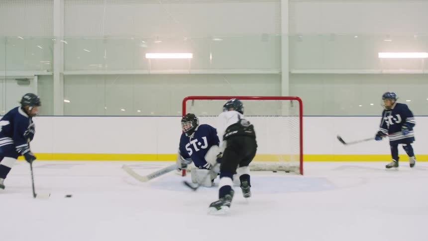 Childrens hockey team playing game on rink