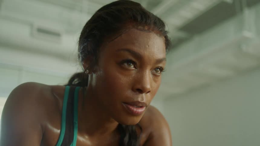 A young woman exercising on a stationary bike