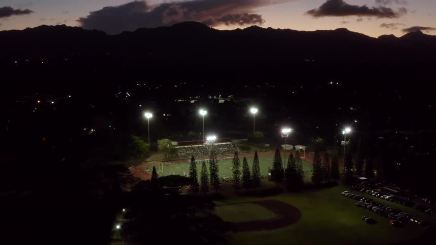 An aerial view of a stadium lit up at night