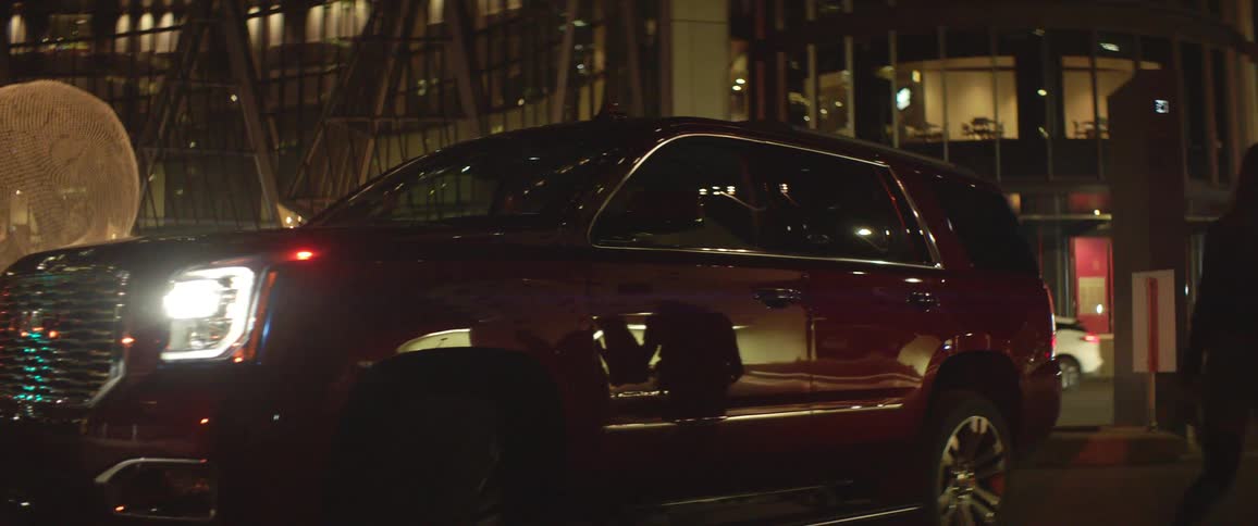 Couple on a date get out of a parked car in the city at night