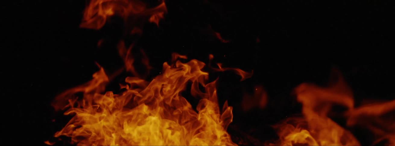 Orange and yellow flames and embers against a black background
