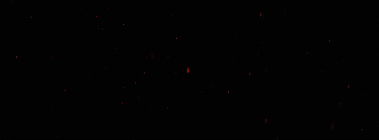 Flames and small sparks against black background