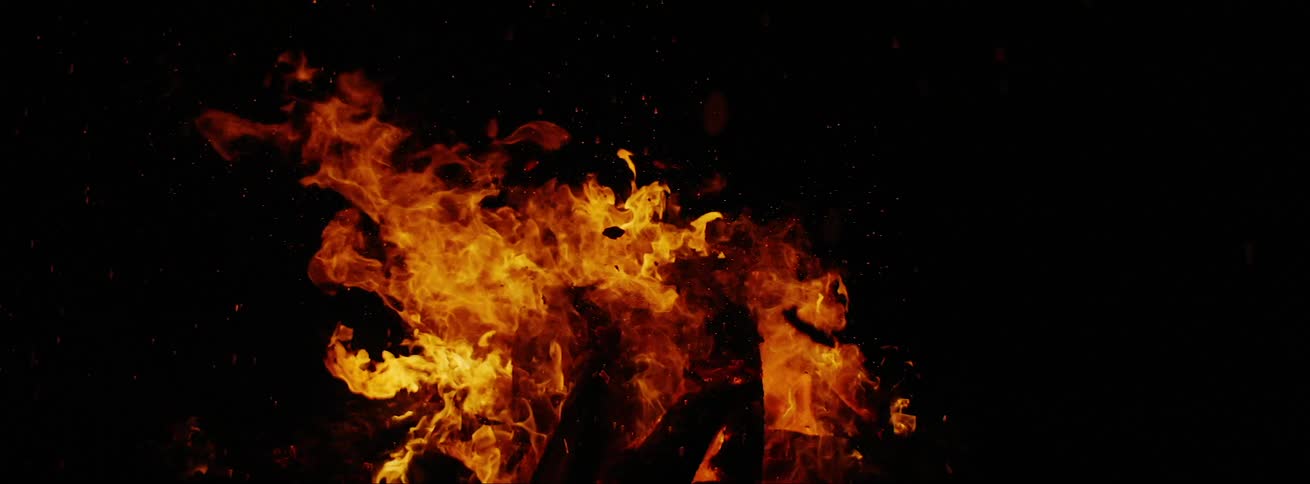 A bonfire is burning at night