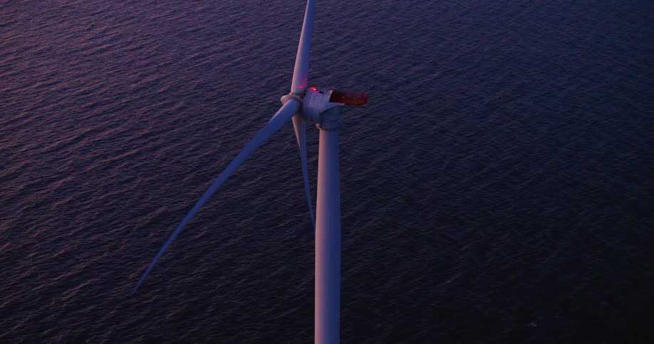 The windmill is turning in the water