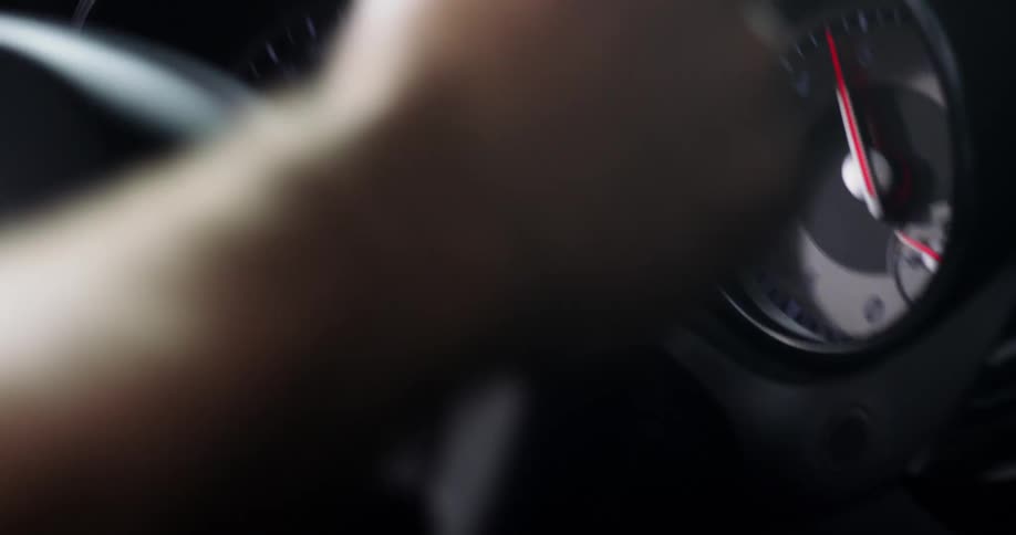 Close up of a persons hands on the steering wheel as they race a car