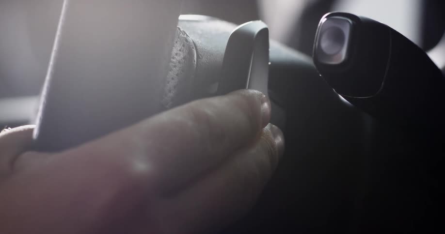 Close up of a mans hand on a steering wheel as he drives