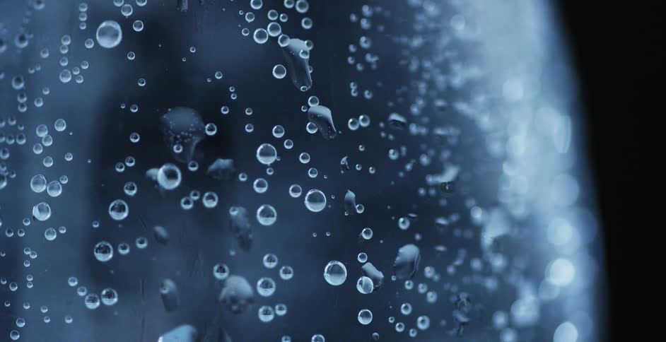 Close up of the bubbles inside of a soda water bottle in a studio