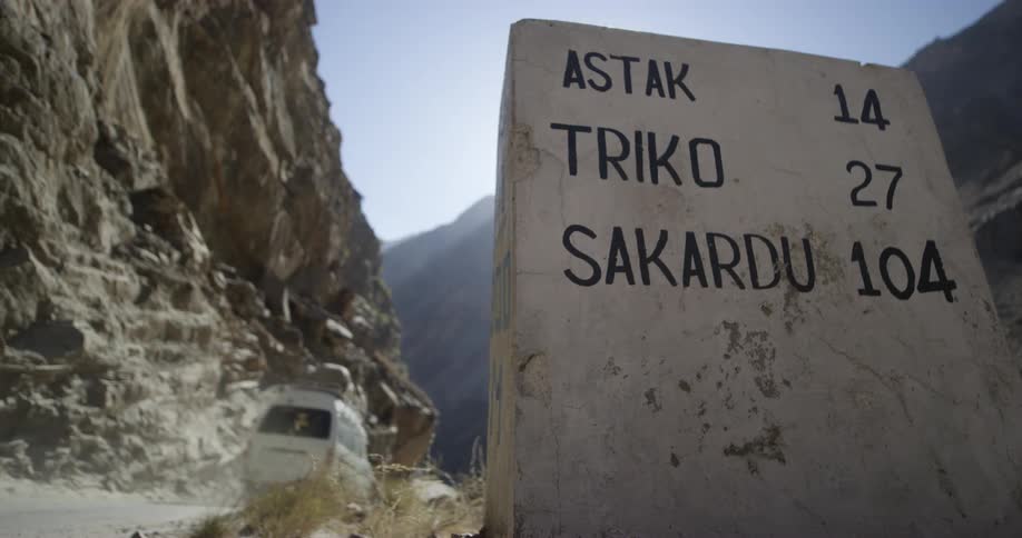 Milestone on the side of a road in the mountains of pakistan