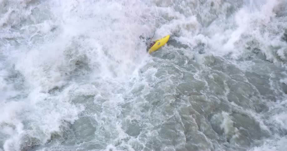 Kayaking through rough ocean waves