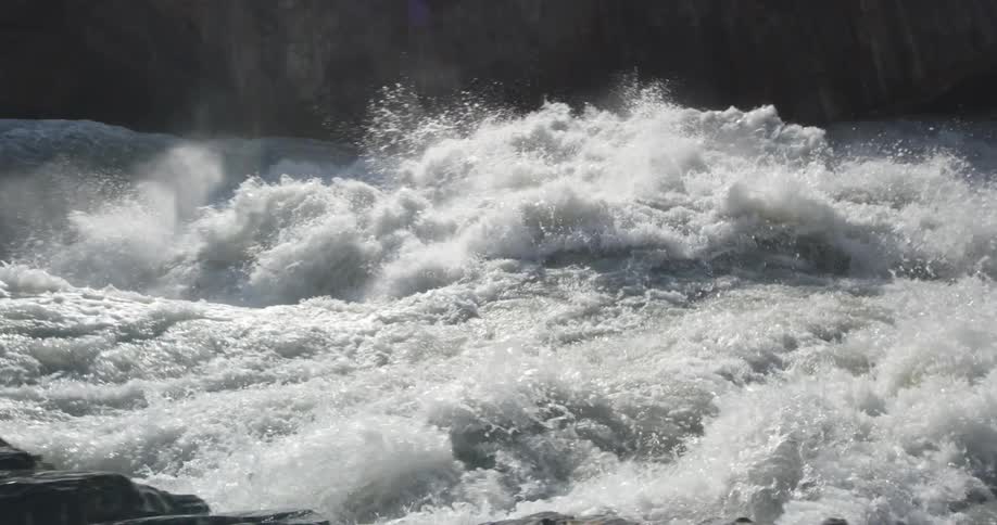 Intense rapids on river between rocky cliffs