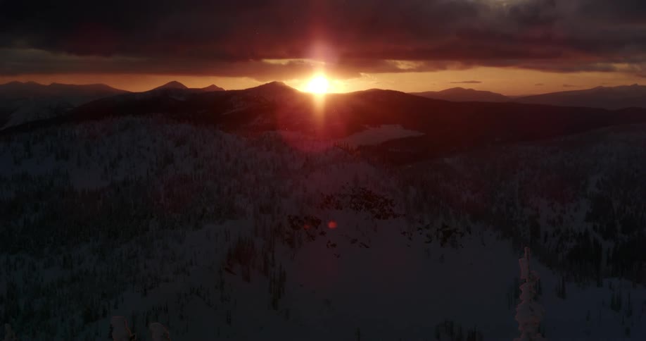 The sun is setting behind the mountain