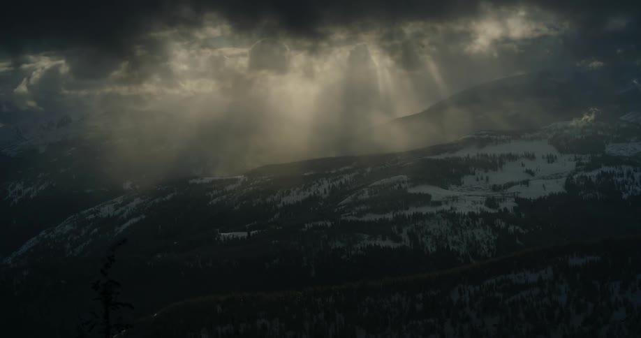 Heavy cloud cover moves over mountain range at dusk
