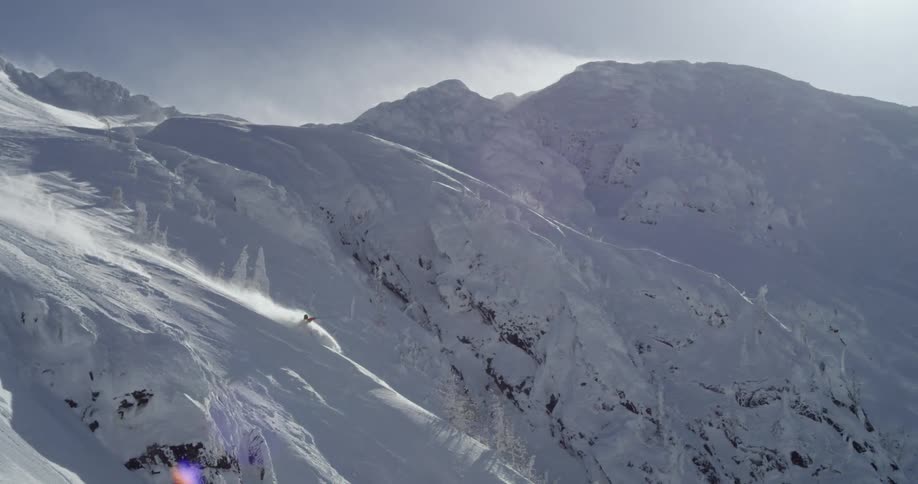 Person skiing down steep mountainside