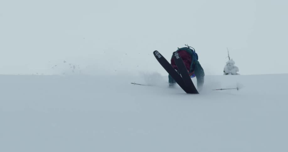 Person skis down steep slope