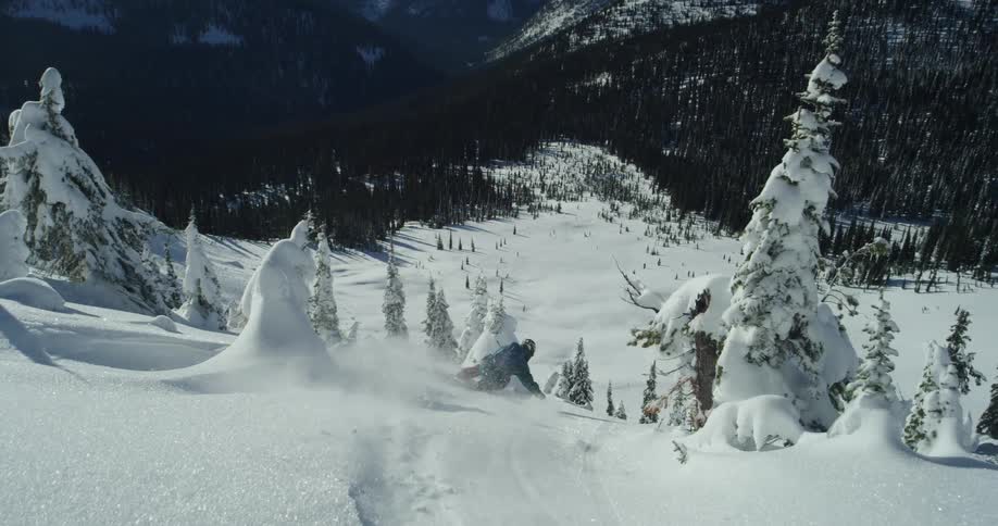 A man is skiing downhill in winter