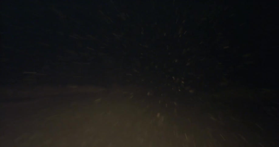 Driving through the night on a snowy road