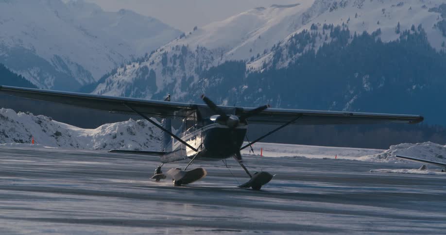 A helicopter is landing on the ice in an arctic area