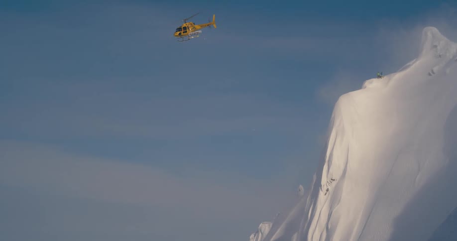 A helicopter flying over a mountain