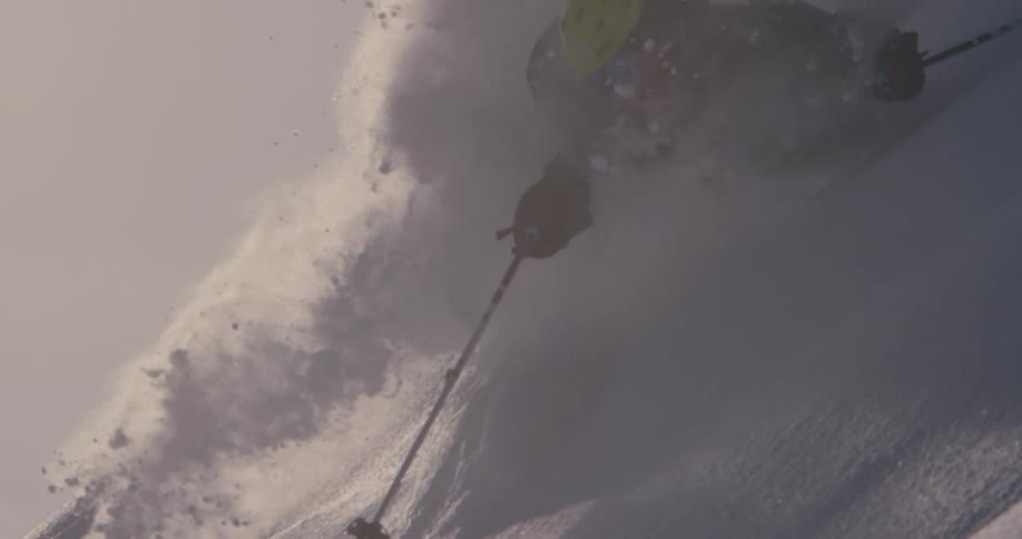 Downhill skier on steep mountain slope