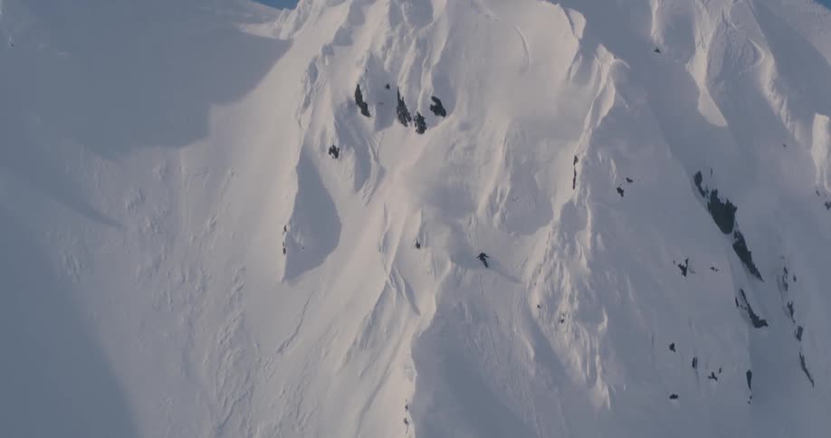 Person skiing down steep mountainside