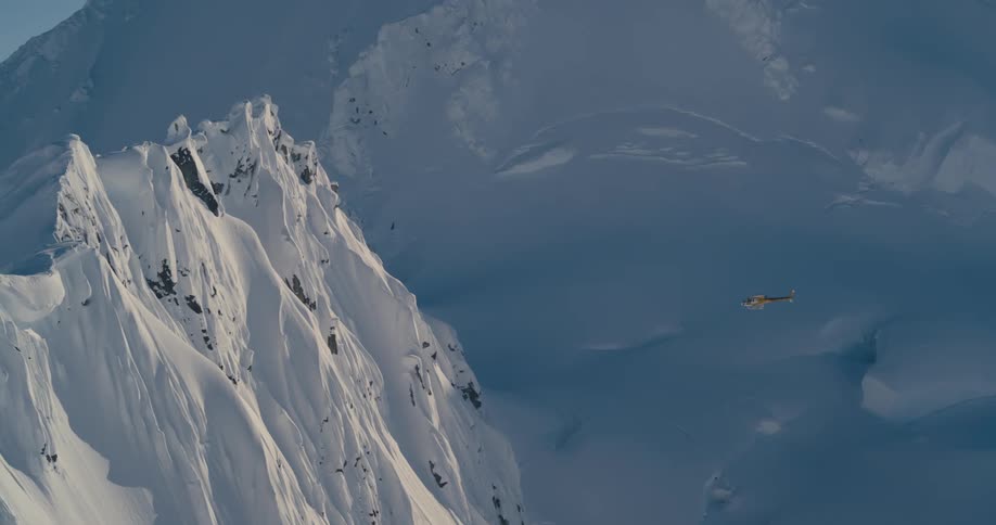 A helicopter flying in a mountain range