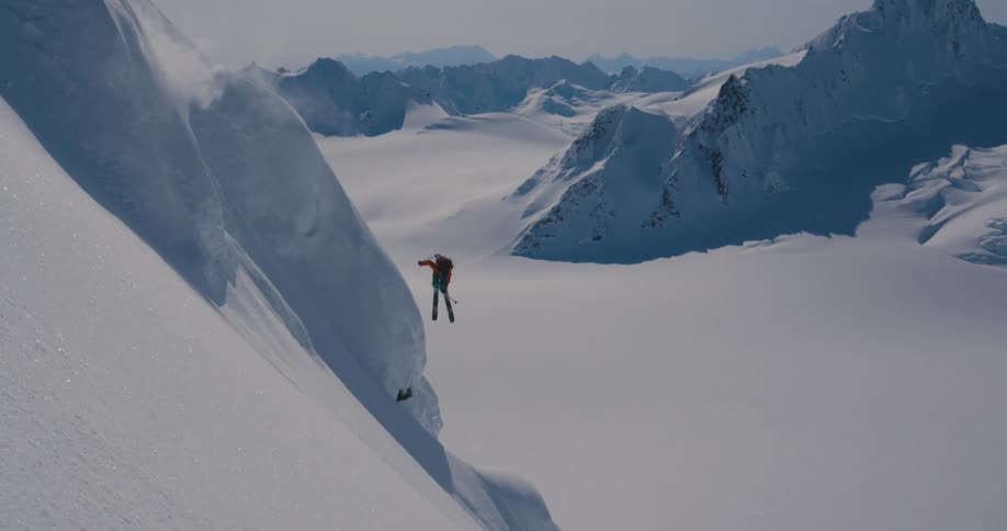 Person skis down steep mountainside