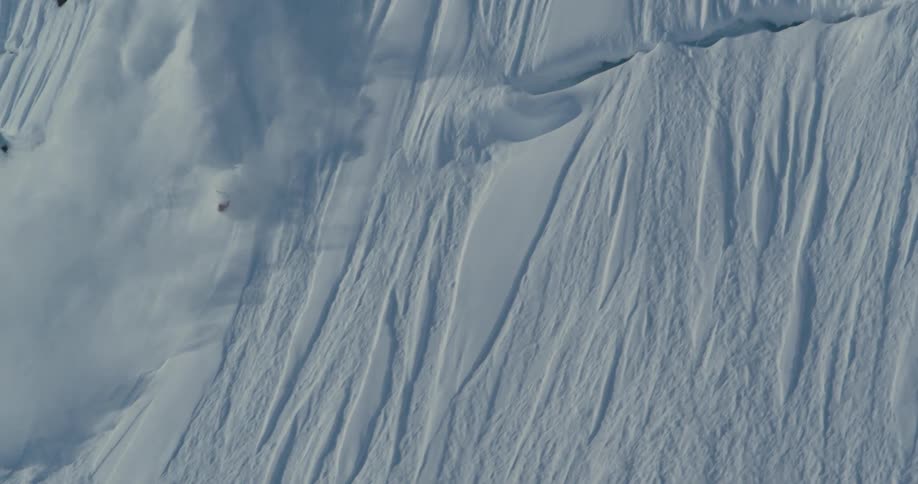 A person skiing down a mountain falls and then gets back up on both skis