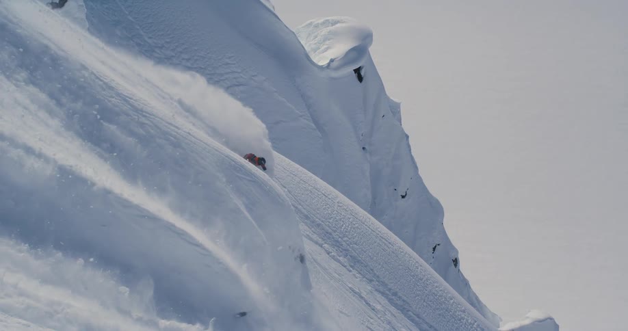 Person skiing down extreme steep mountainside