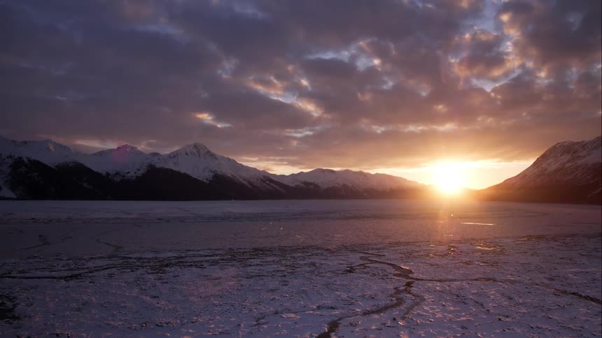 Aerial pull over ice flow in the arctic at sunset