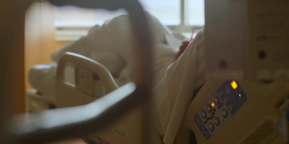 A person lying in a hospital bed