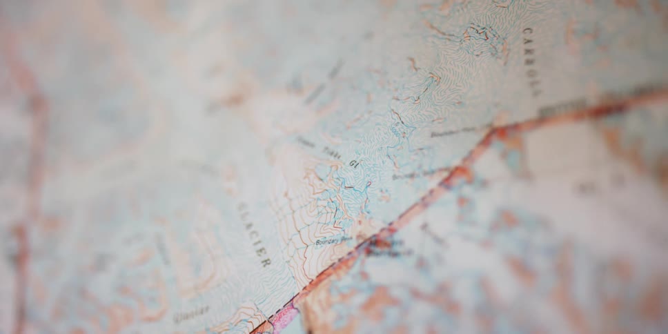 Out of focus close up of the contour lines of a geographic paper map
