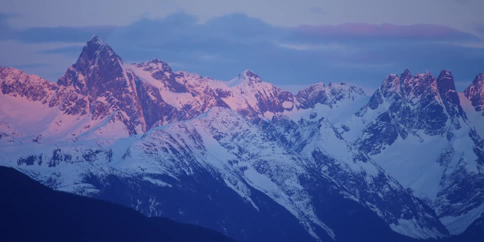 View of snow capped mountains at dusk