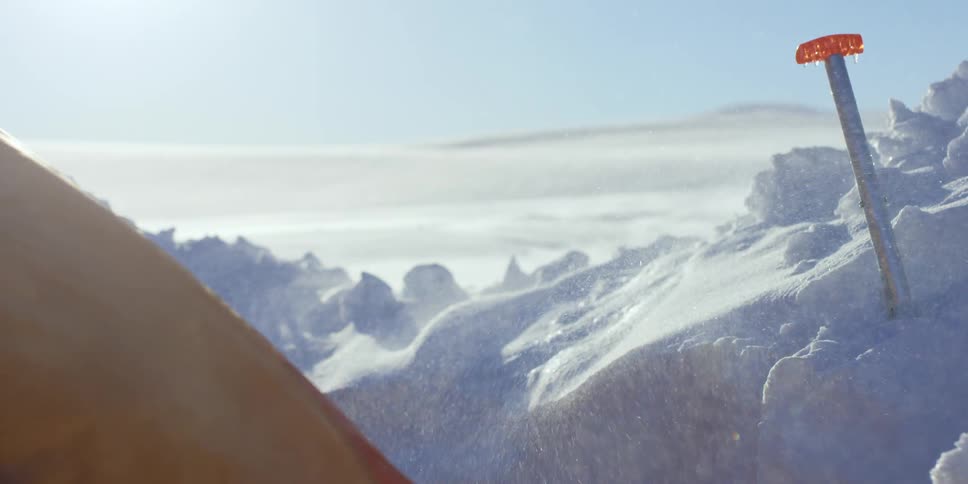 Snow blows over a tent
